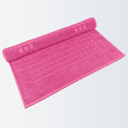Fuchsia Pink cotton bath mat in quick-dry textured finish on white background