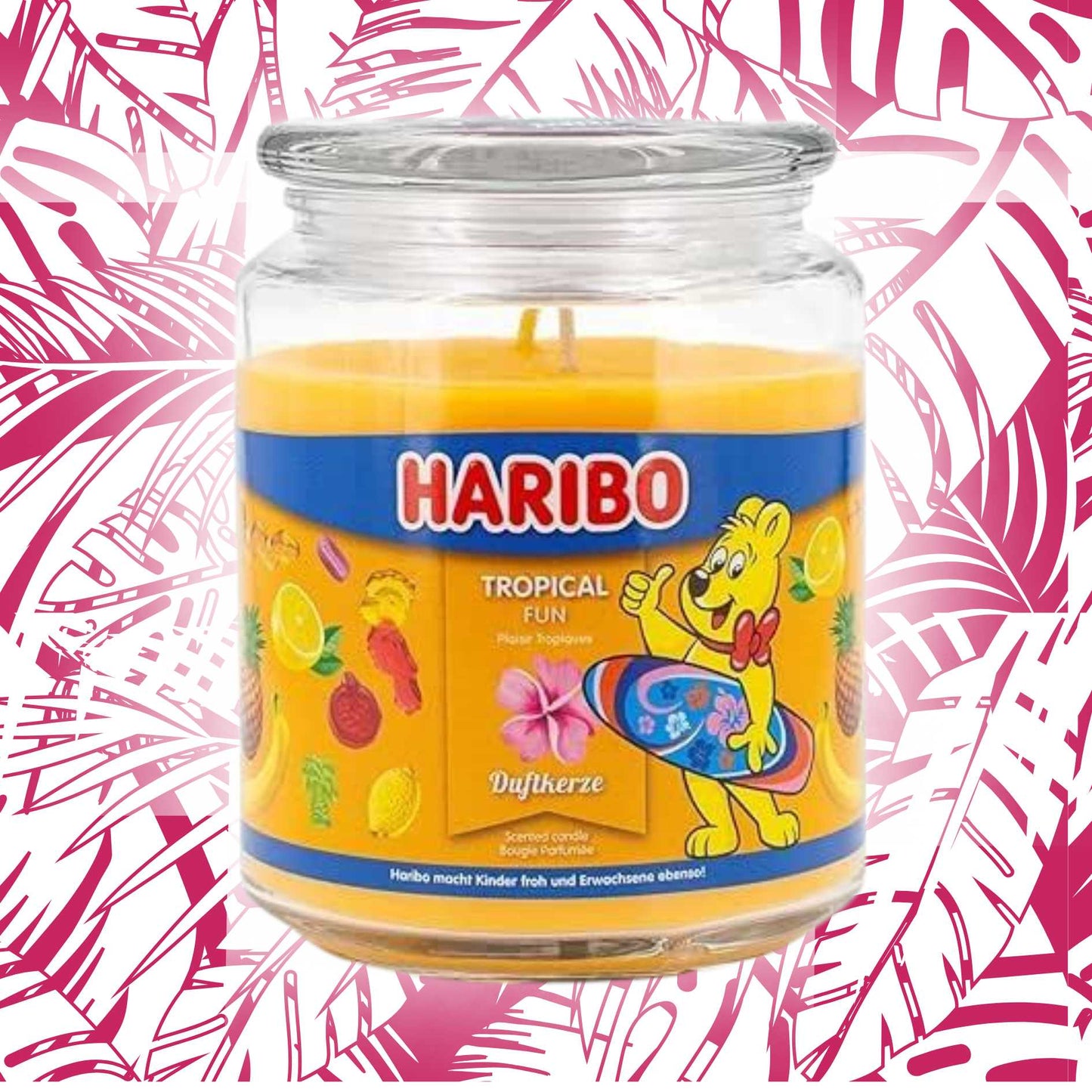 Haribo candle in a jar with a colorful label on a pink and white tropical background