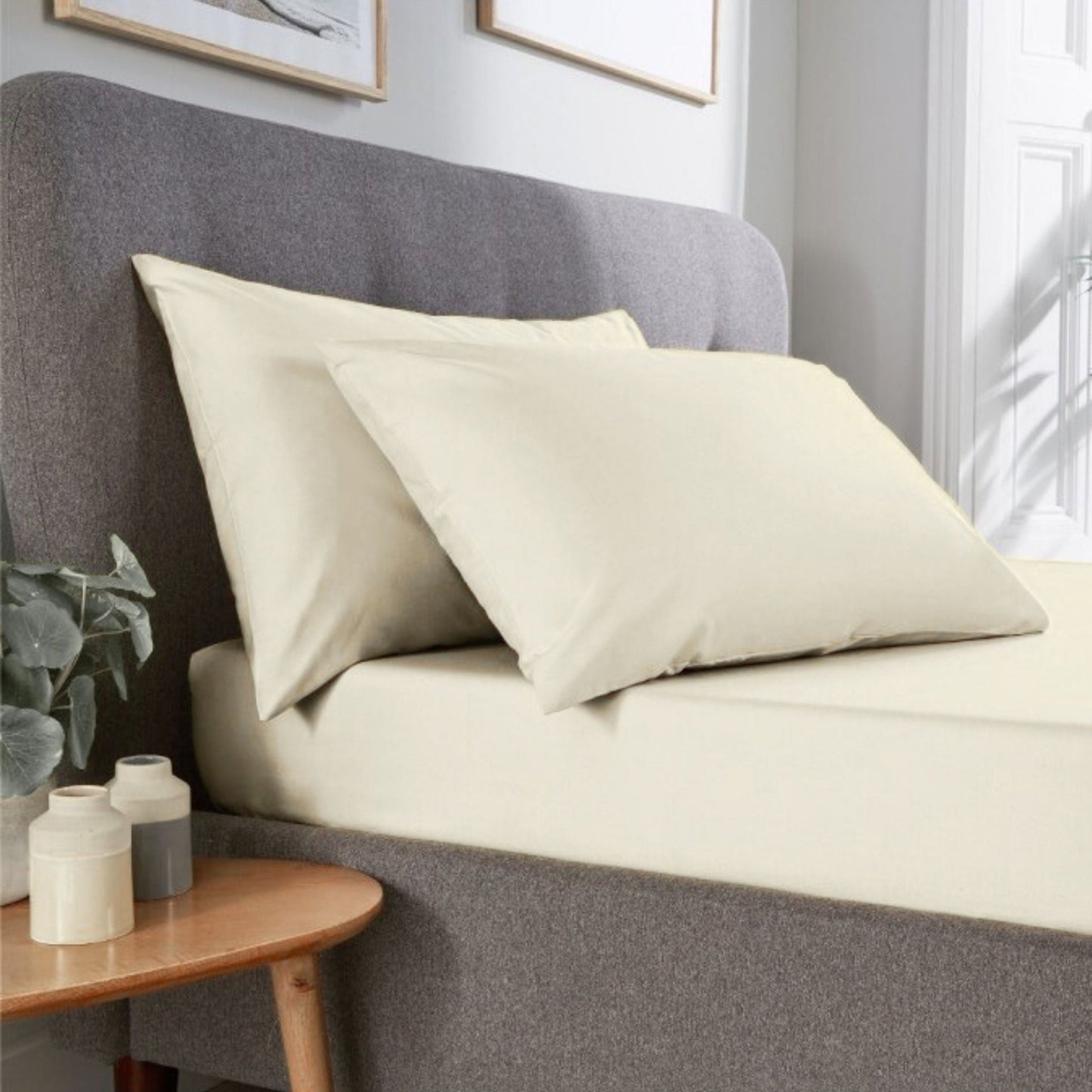 Ivory Percale pillowcase pair made from polycotton blend displayed in a contemporary hotel room setting