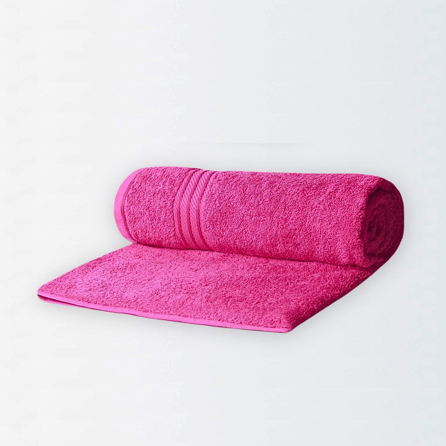Rolled bright pink bath towel on a white background