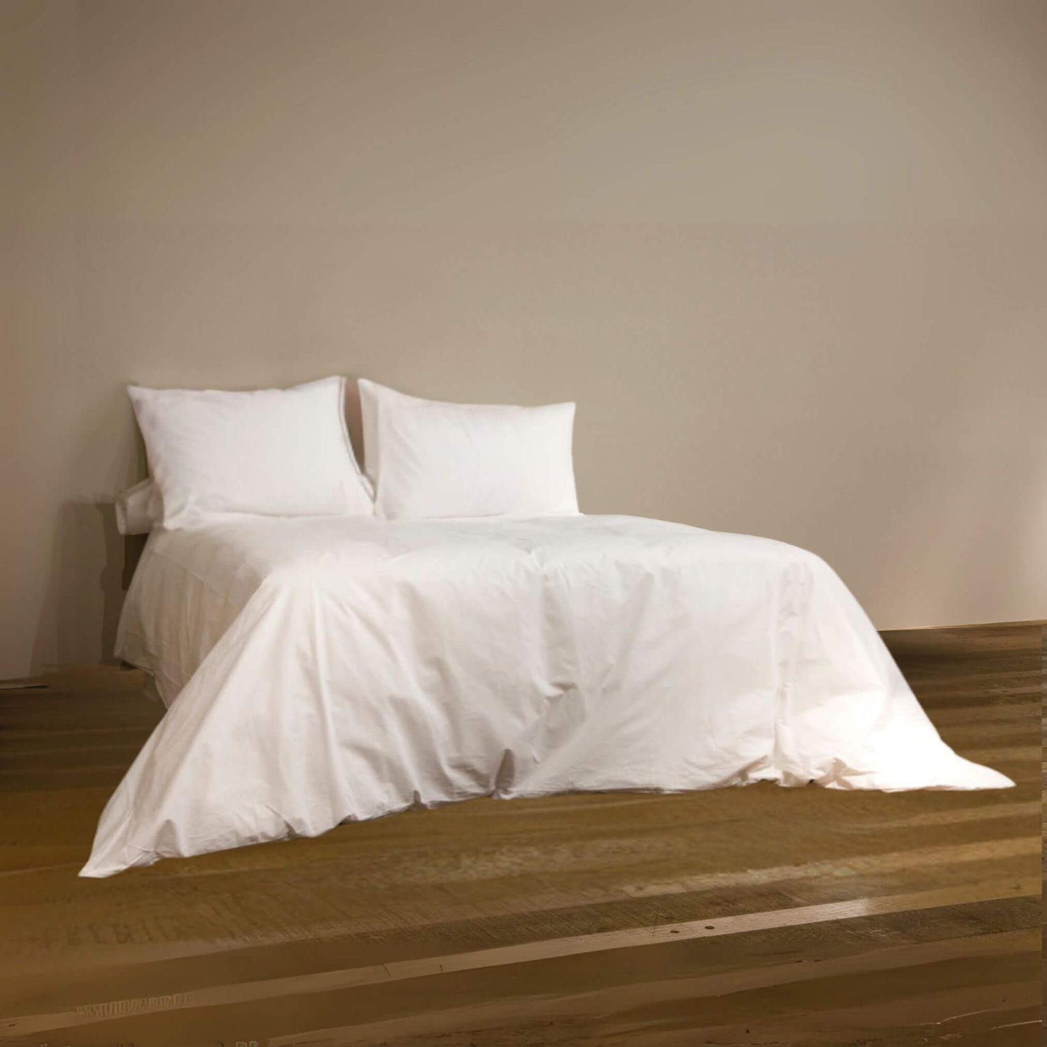 double bed dressed with white cotton bedsheets