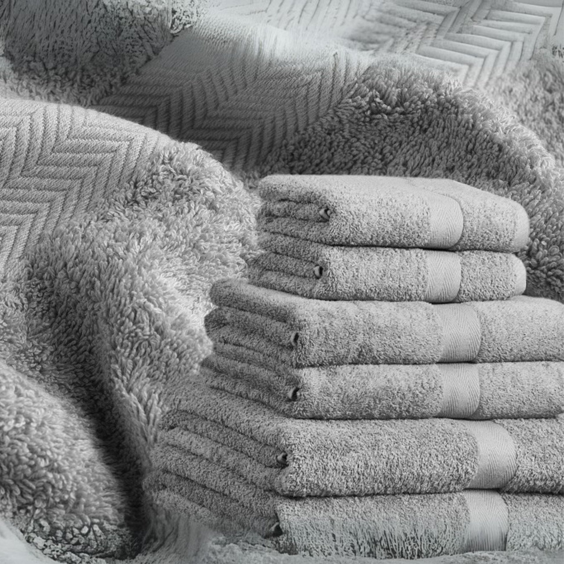 Silver grey bathroom towel, combed cotton, 500GSM, folded and stacked, luxury hotel quality.