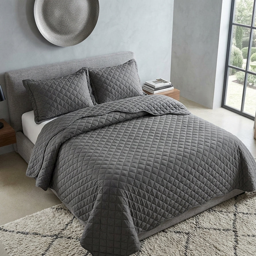 dark grey quilted bedspread with diamond stitch pattern in modern bedroom