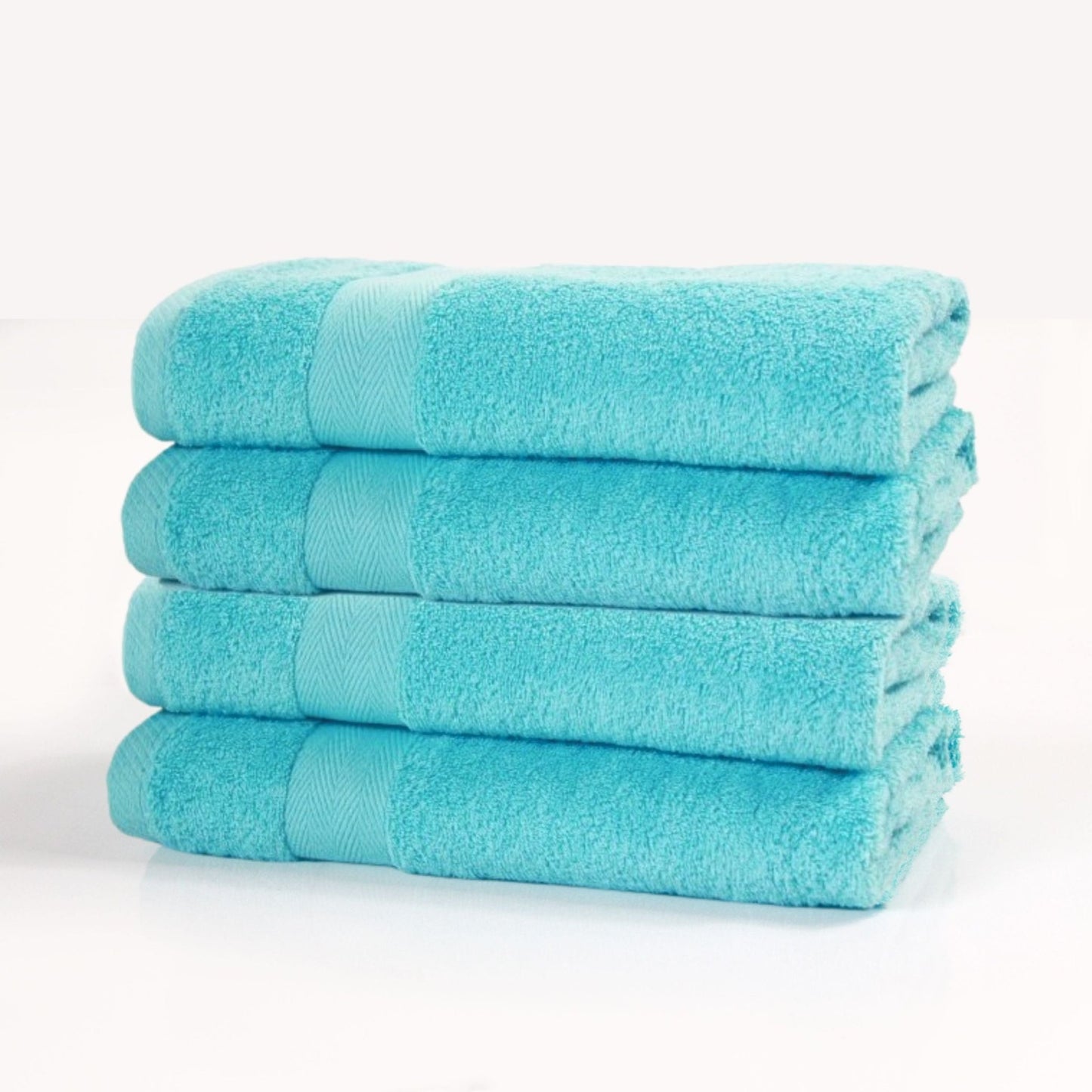 Stack of four luxury cotton bath towels in turquoise, made from 600 gsm pile on a white background