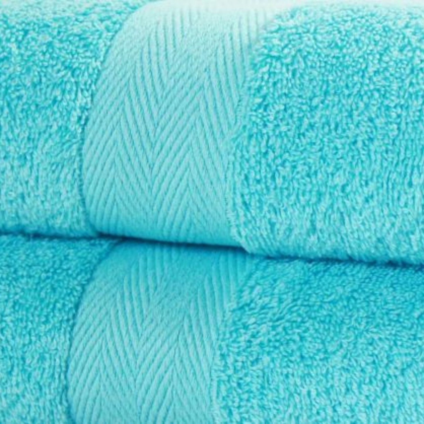 Close-up of turquoise bath towels in fine combed cotton and 600 GSM pile.