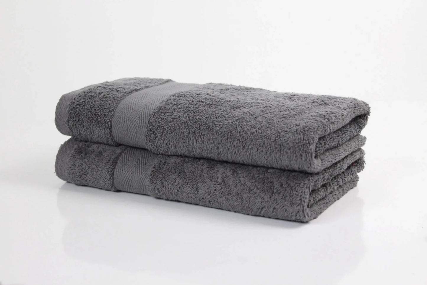 Pair of charcoal luxury bathroom towels made from fine combed Cotton and 600GSM pile on white background