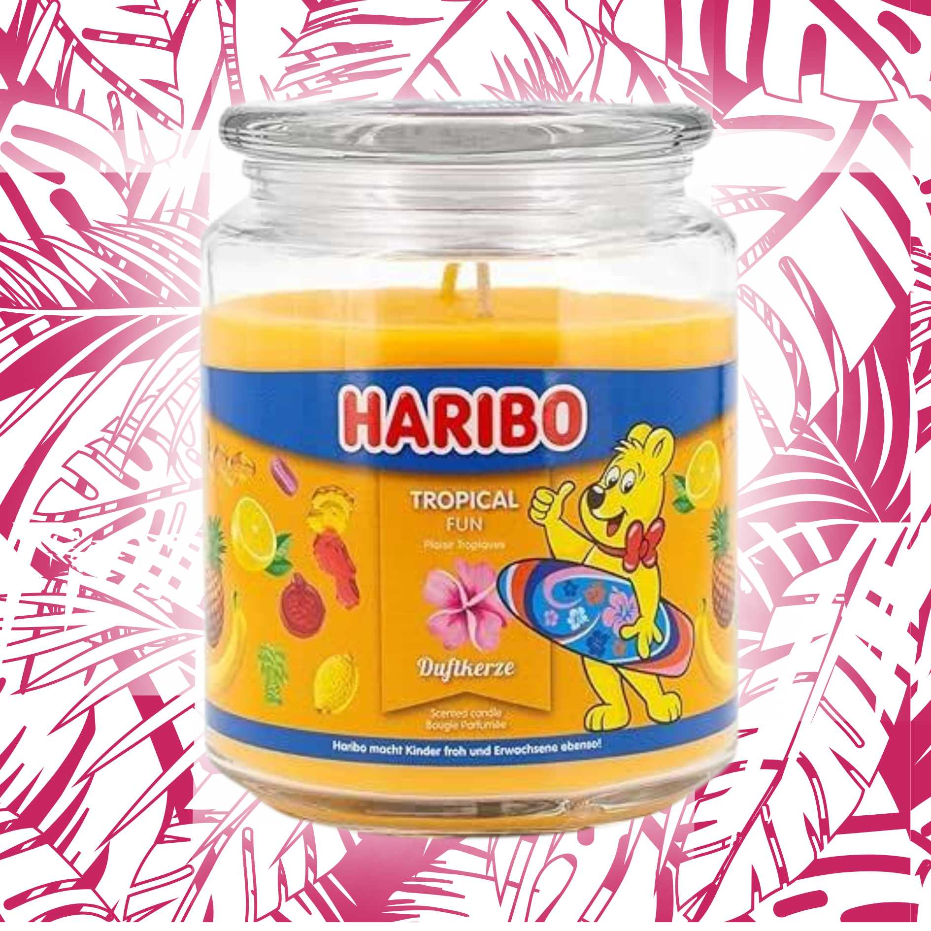 Haribo candle in a jar with a colorful label on a pink and white tropical background