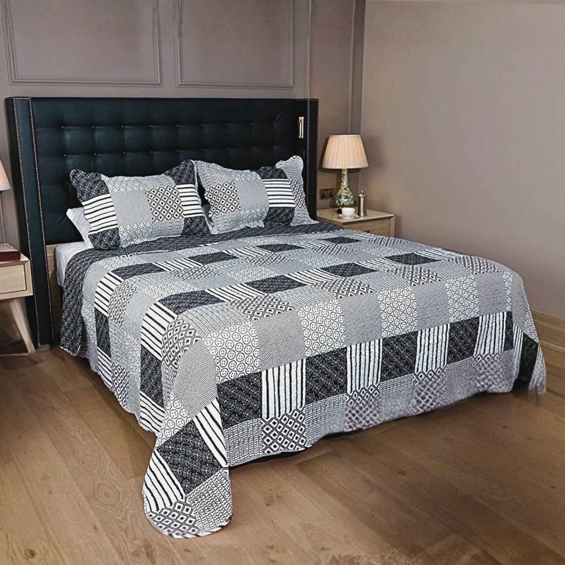 King Size Bed with a geometric patterned bed spread and matching pillows in a bedroom setting.