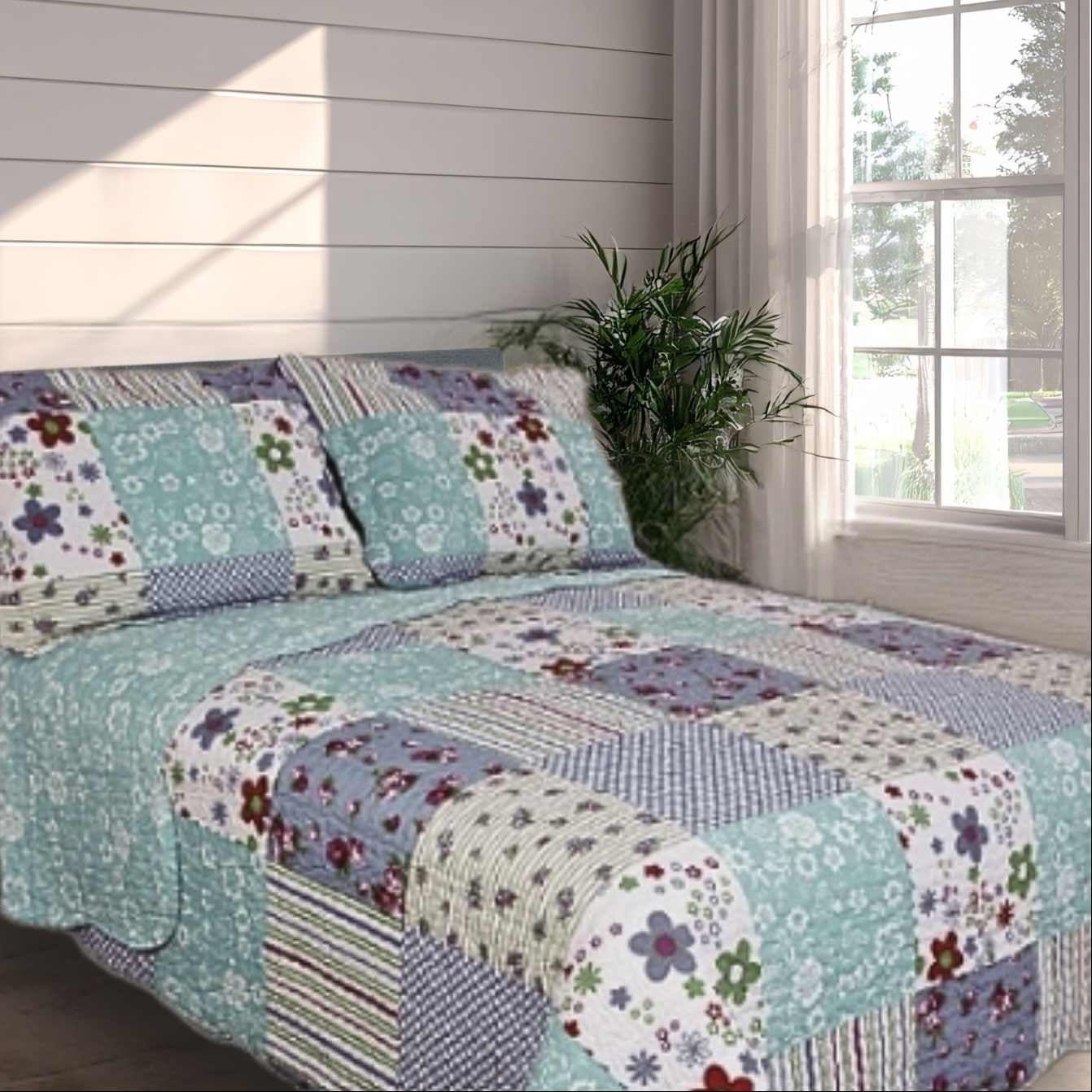 Bed spread with patchwork pale green and lilac, floral design on a white background.