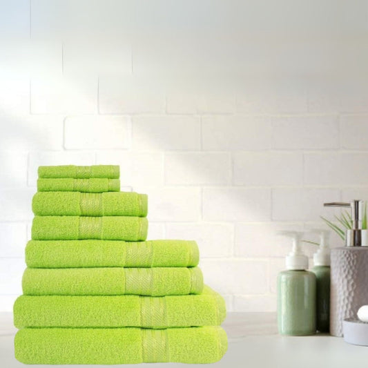 Stack of 500 gsm lime green fine combed cotton bath towels on a white surface with a tiled wall background