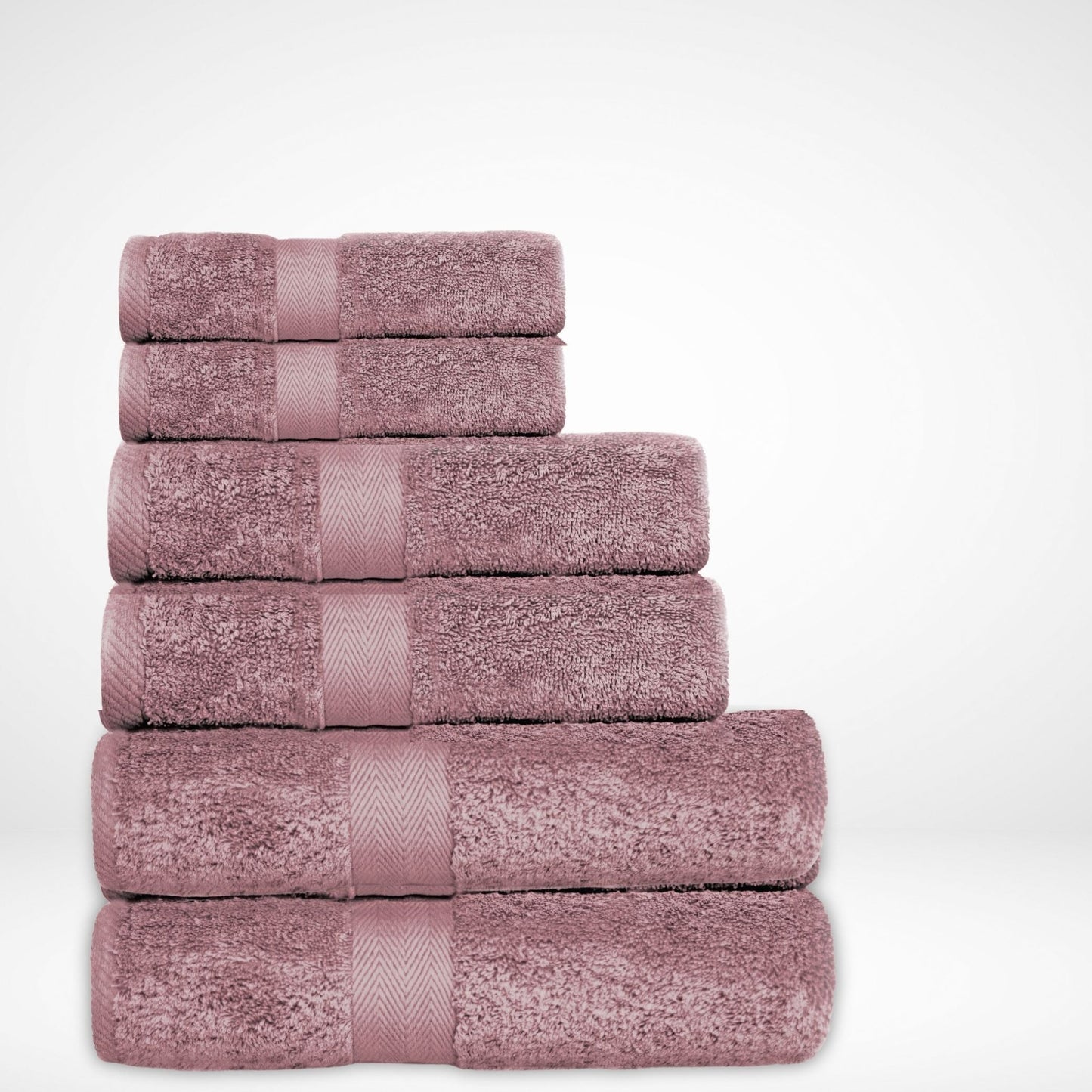 Luxury cotton bath towel stack in Mauve, made from combed cotton and a thick 600 GSM pile on a white background.
