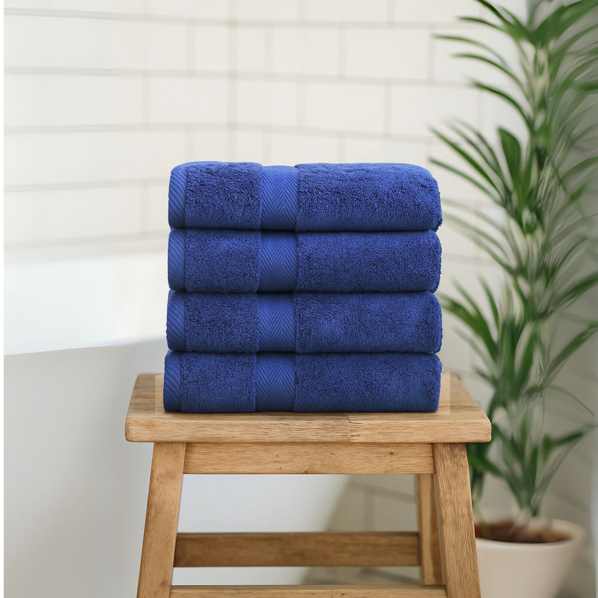 Luxury bathroom towel stack in Navy Blue, made from fine combed cotton and 600GSM thickness.