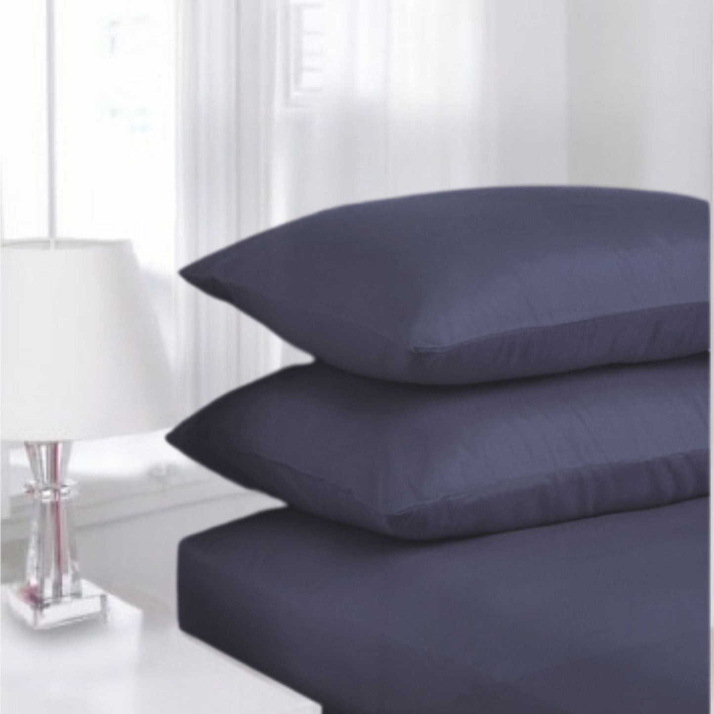 Navy Blue Percale Fitted Sheet made from polycotton blend displayed in classic white guest room setting