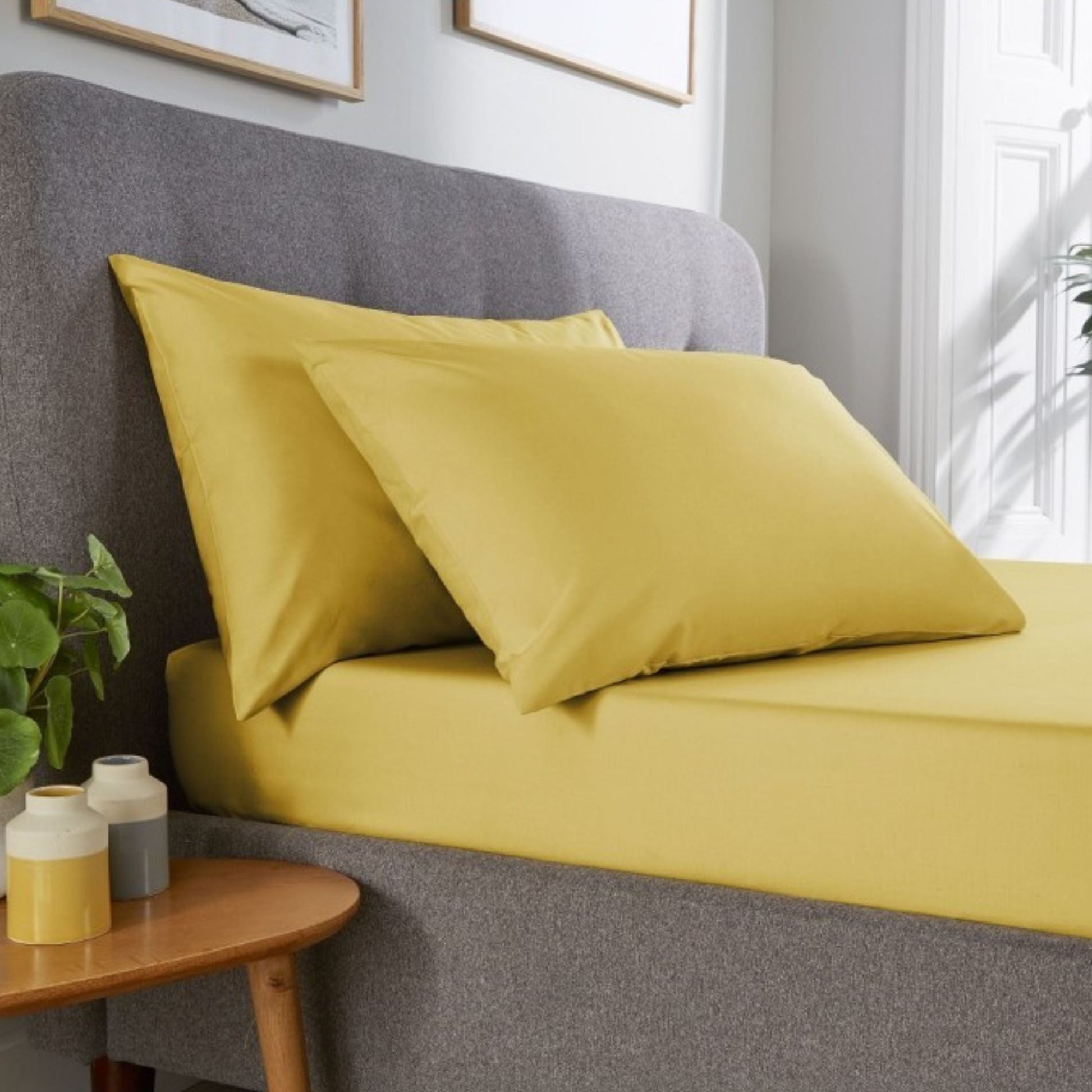 Ochre Yellow Percale pillowcase pair made from polycotton displayed in classic hotel room setting