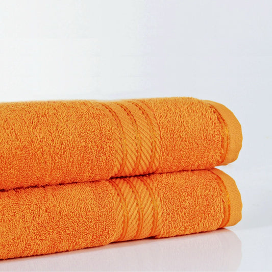 Pair of 500 GSM Orange bathroom towels made from fine combed cotton on white background