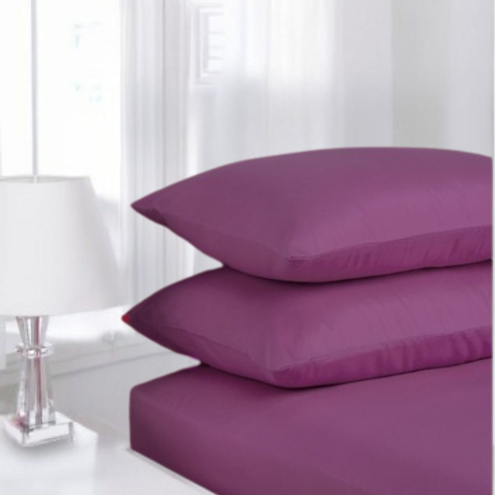 Purple Aubergine Fitted Sheet made from polycotton blend displayed in classic white guest room setting