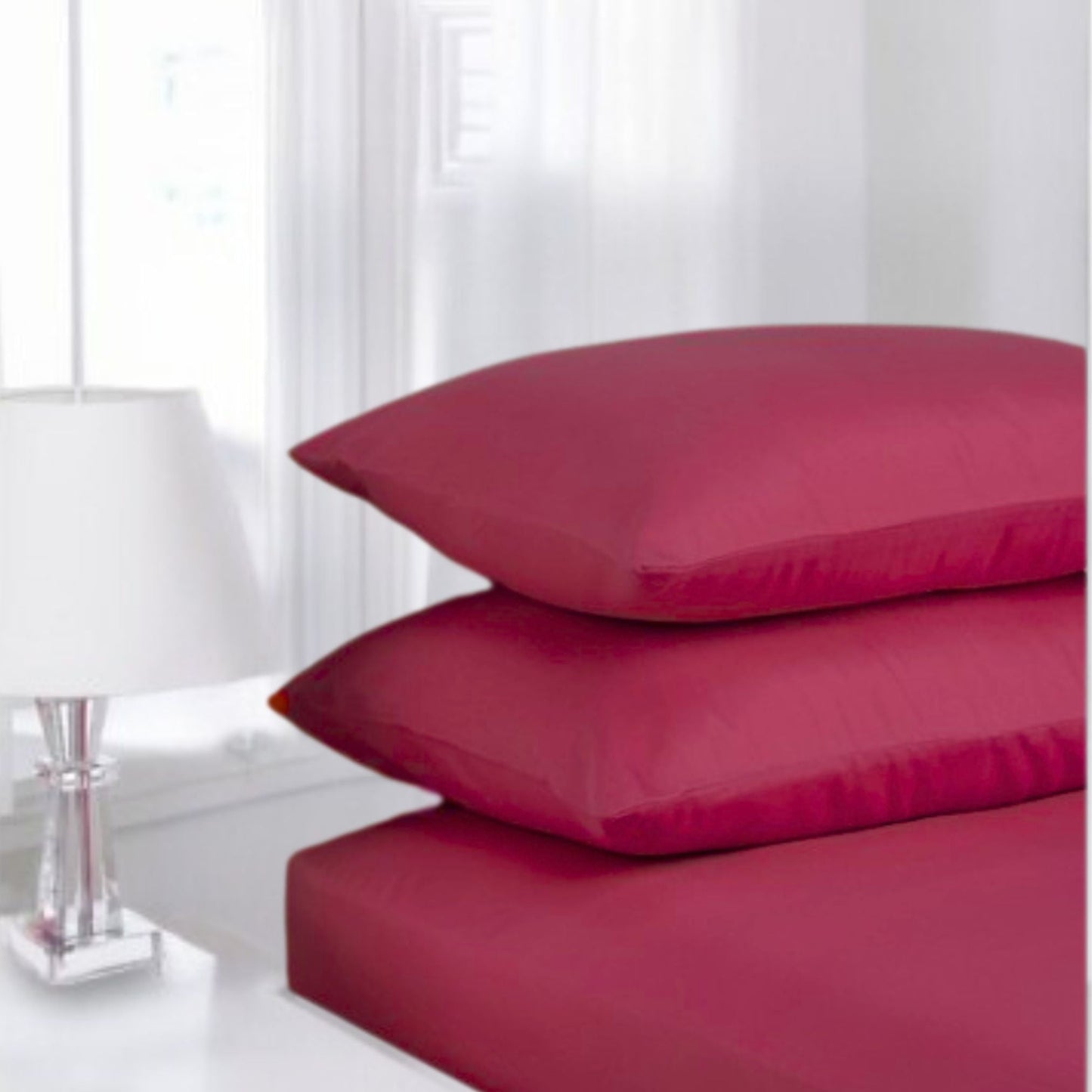 Red Berry Percale fittedsheet made from polycotton blend displayed in classic white guest room setting
