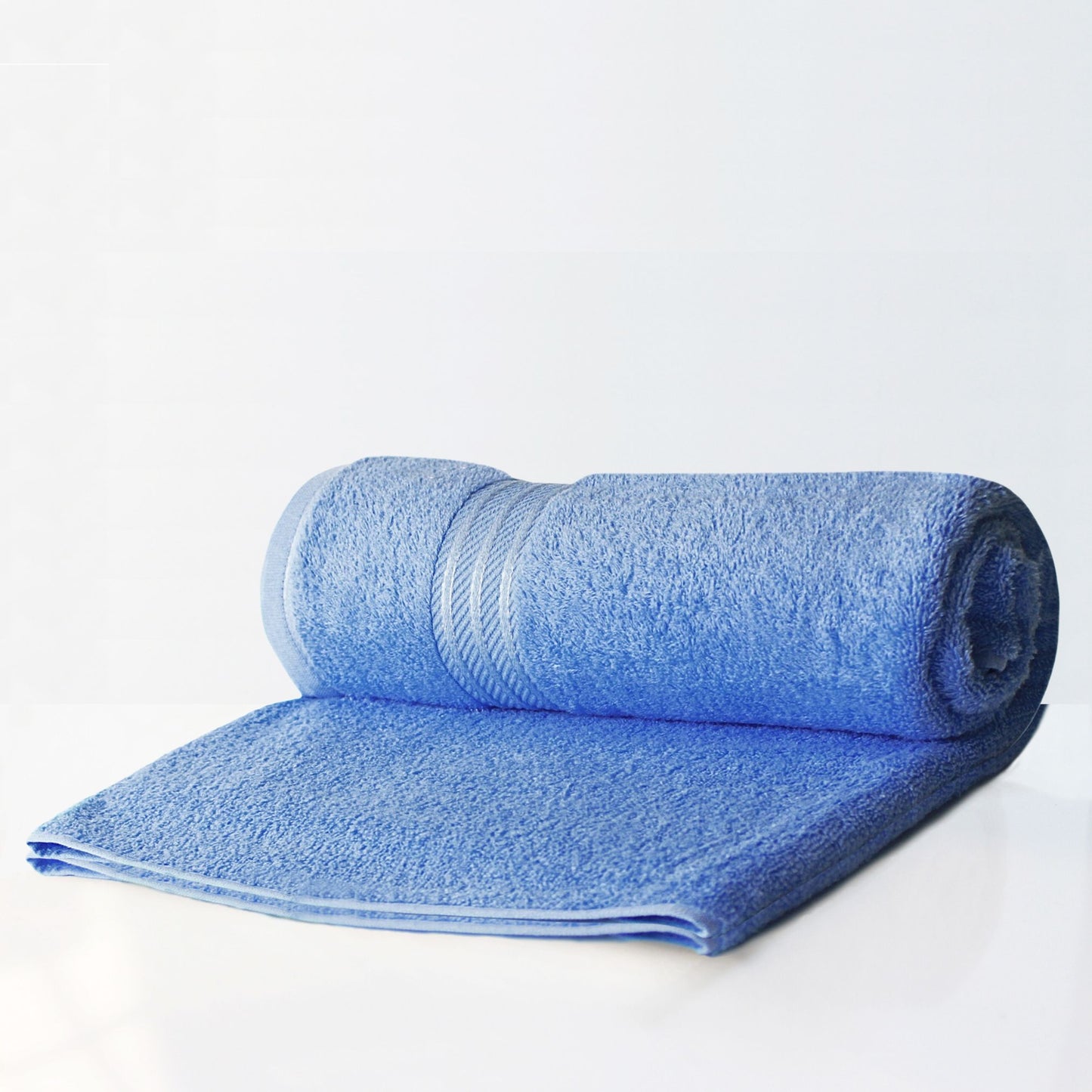 Rolled-up  large blue bath sheet on a white background