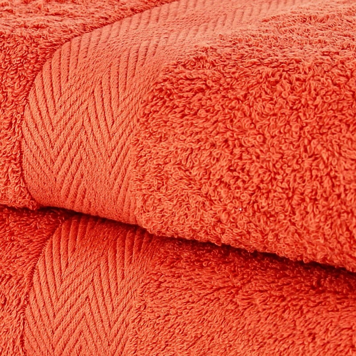 Close-up of orange bathroom towels with a textured surface