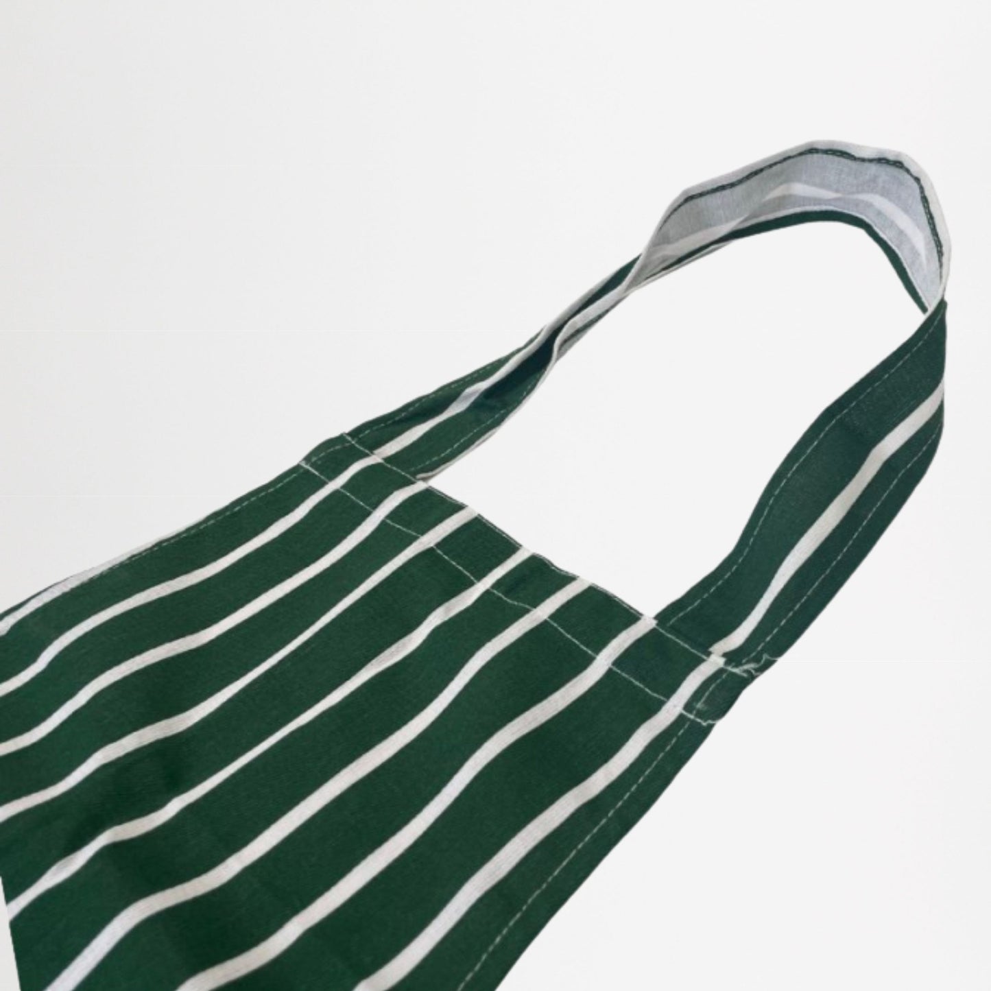 Green and white striped apron on a light grey background
