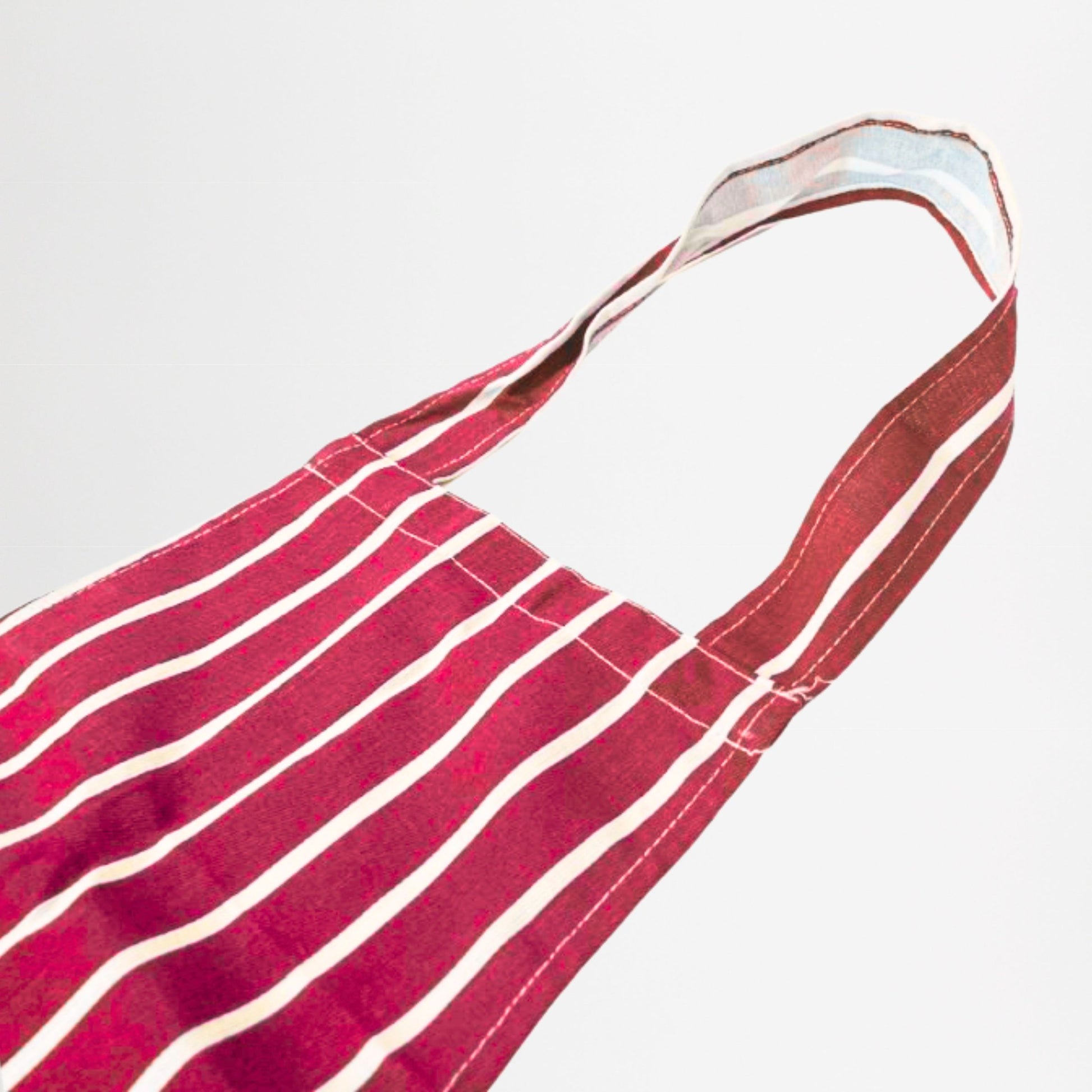 Red and white striped apron on a light grey background