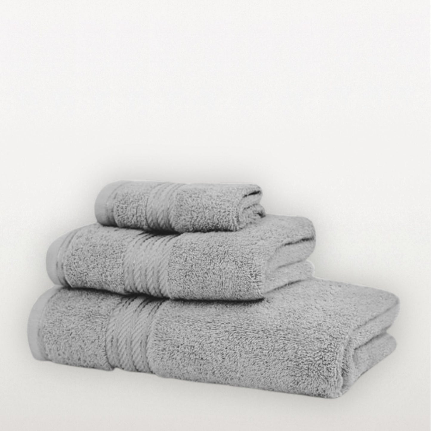 Stack of three grey towels on a white background