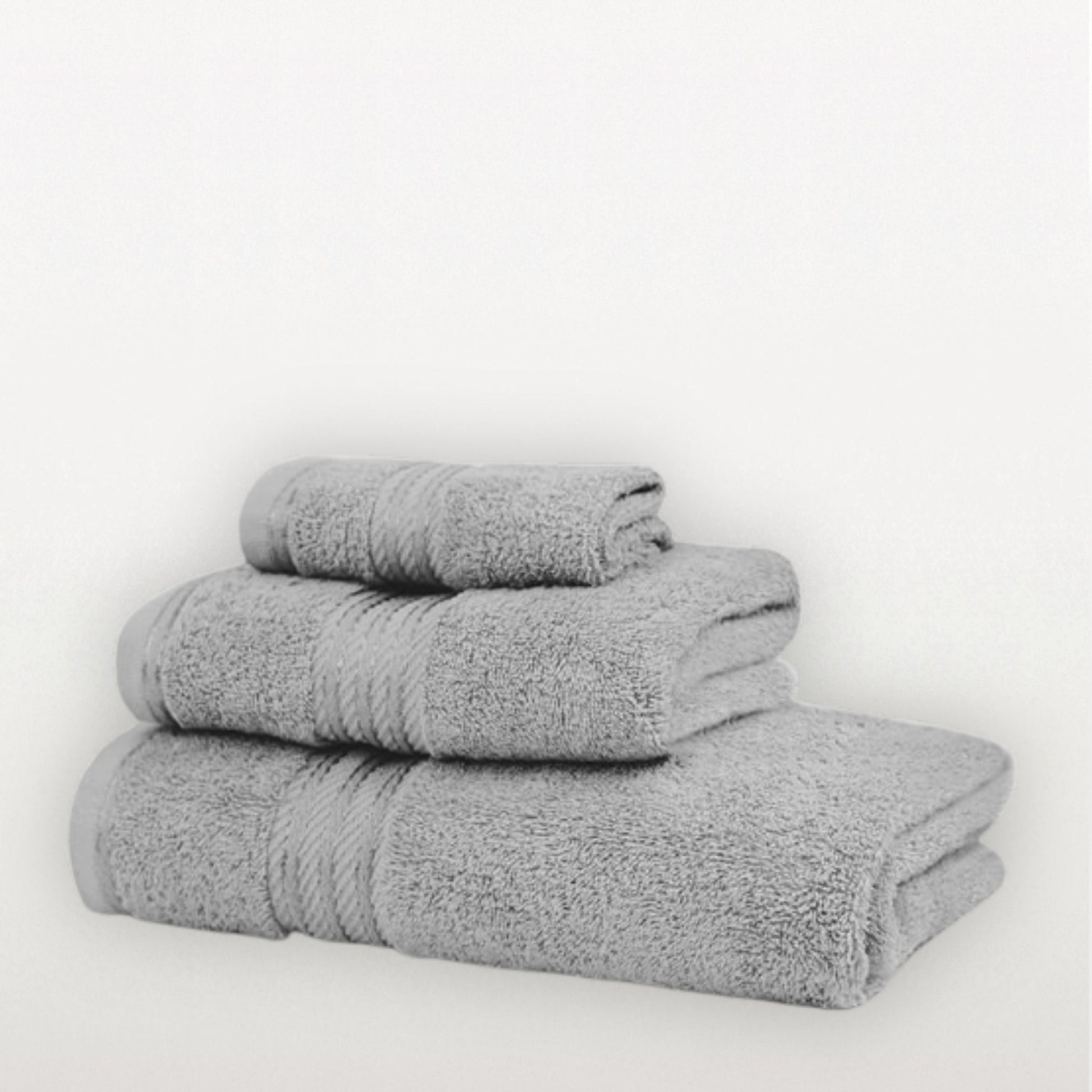 Stack of three grey towels on a white background