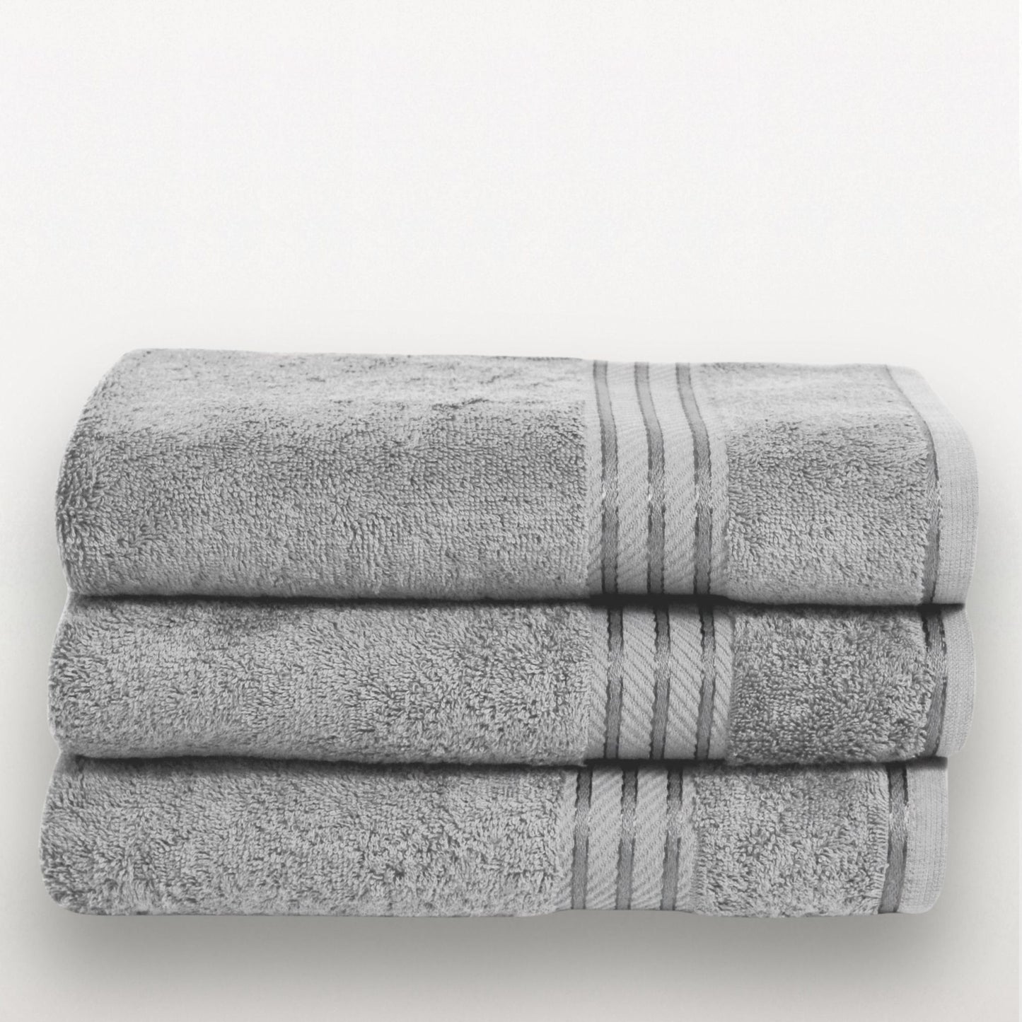 Stack of grey bath towels with satin border on a white background.