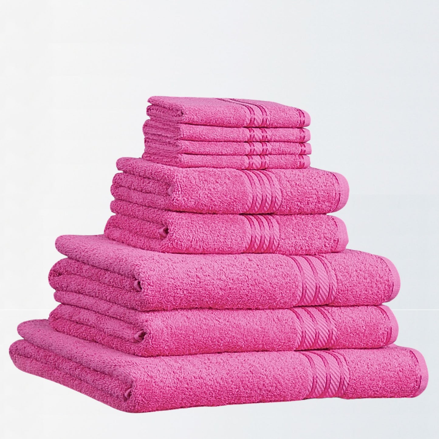 Stack of fuchsia pink bathroom towels on a white background