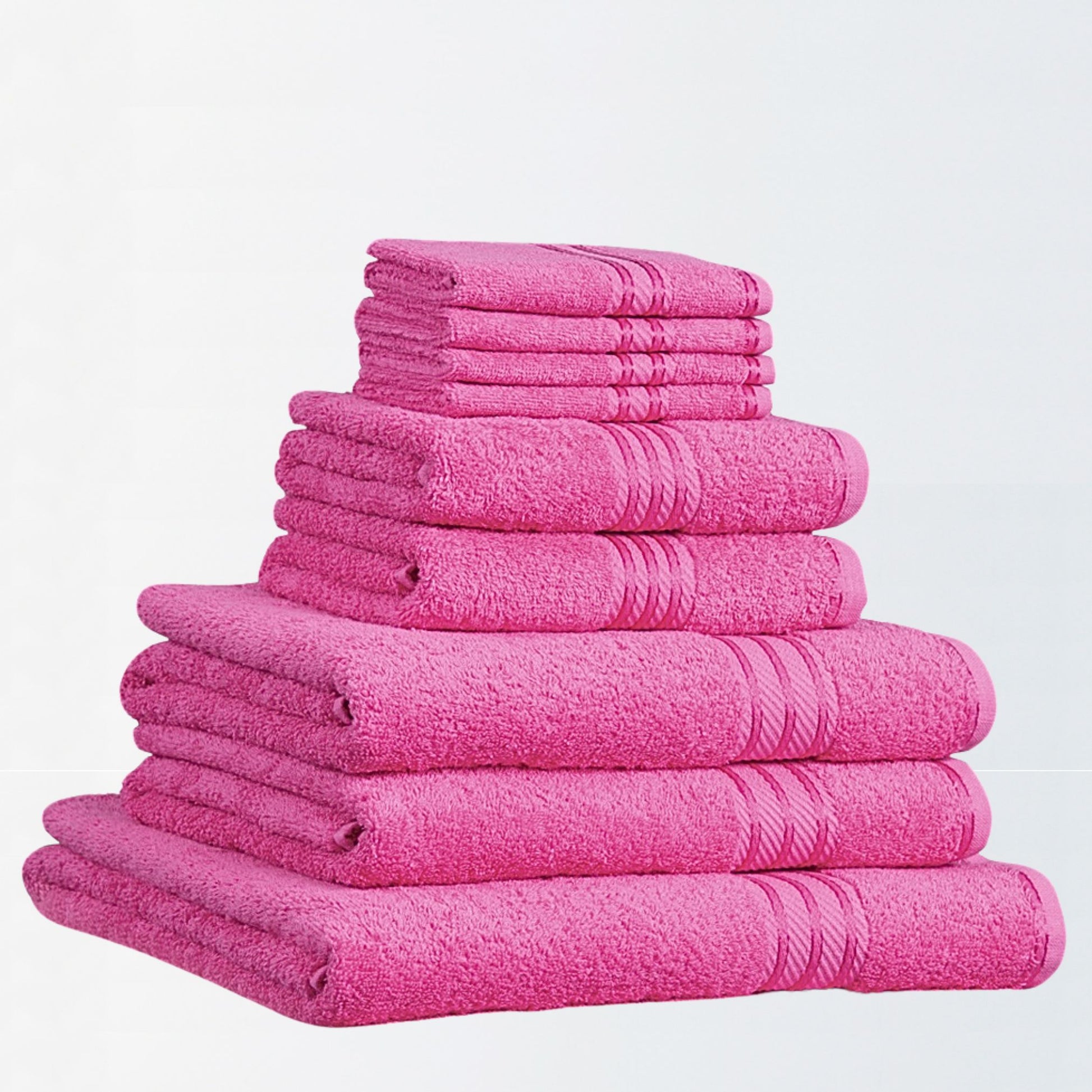 Stack of fuchsia pink bathroom towels on a white background