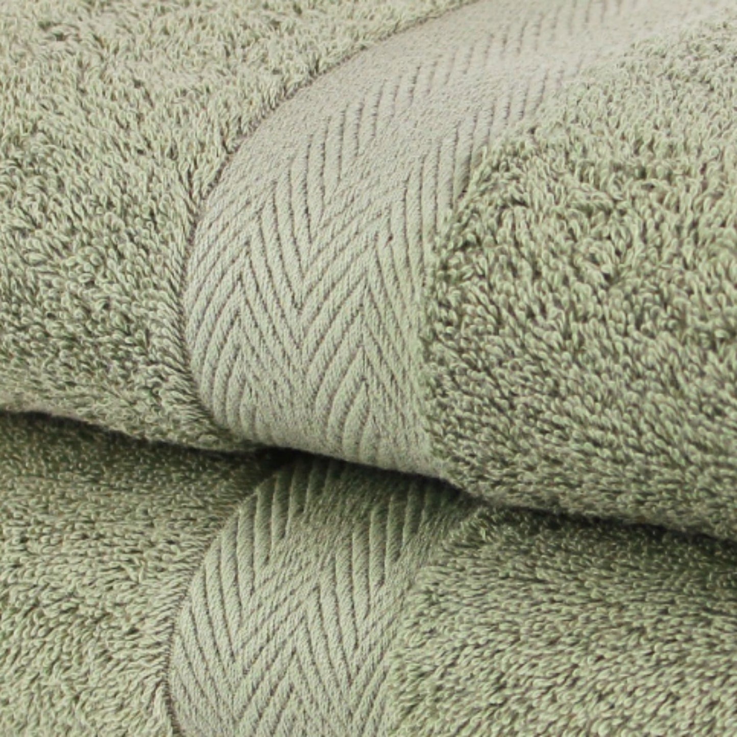 Close of  premium bath towels in Sage Green, made from fine combed cotton and a thick 600 GSM thickness. 