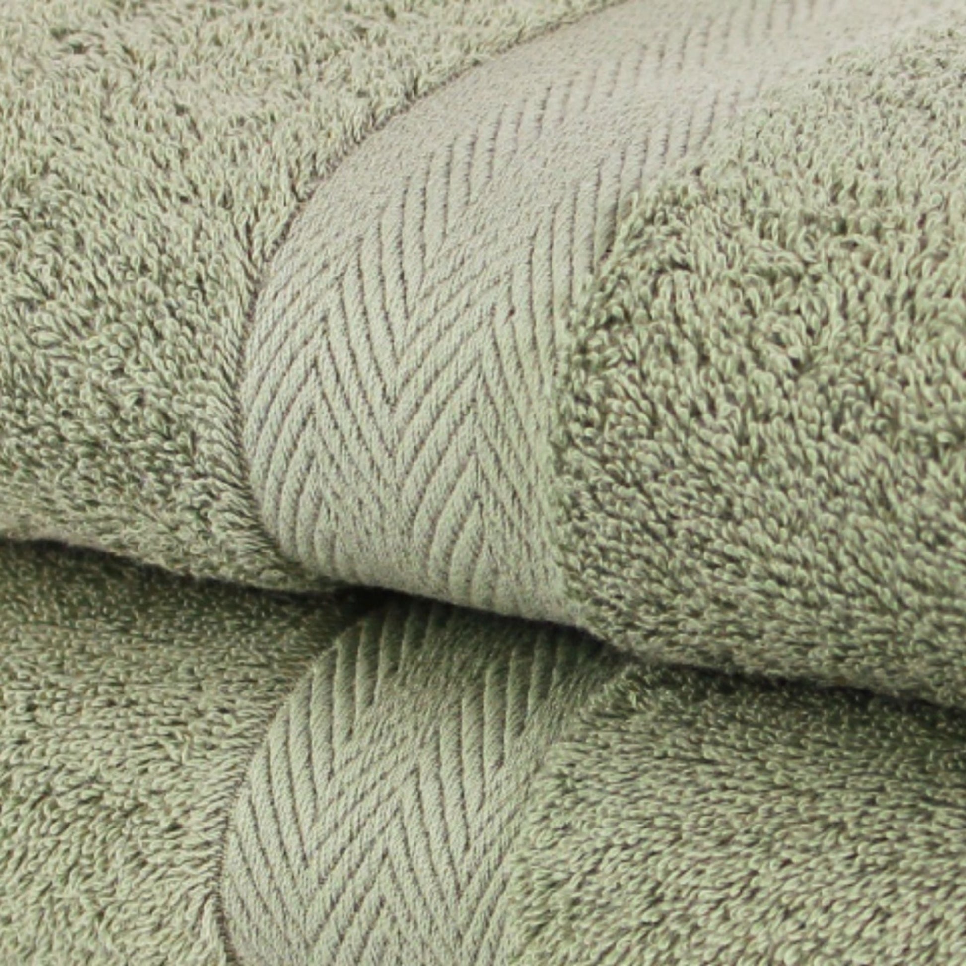 Close of  premium bath towels in Sage Green, made from fine combed cotton and a thick 600 GSM thickness. 