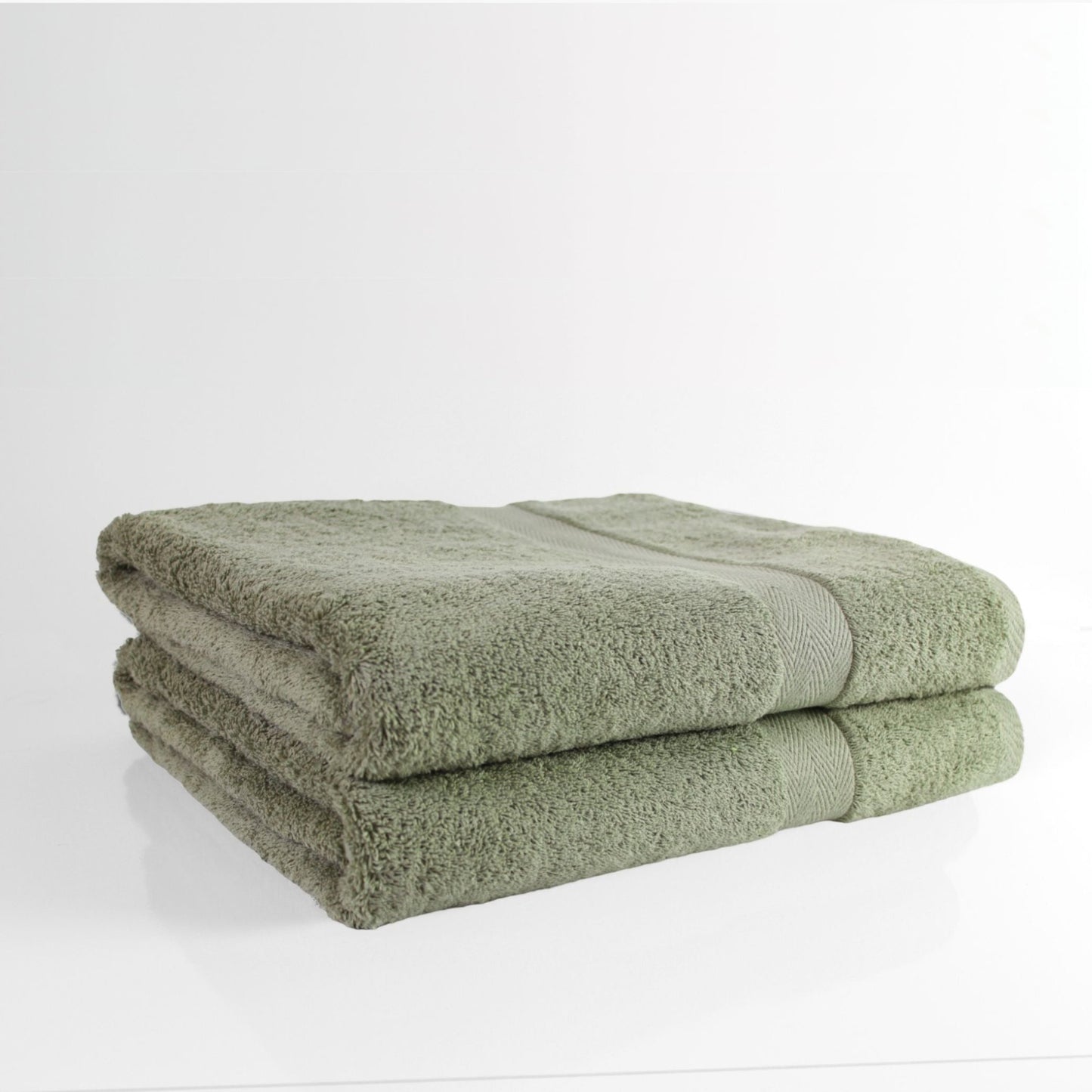 Two luxury Sage Green towels in 600GSM, fine combed cotton stacked on a white background