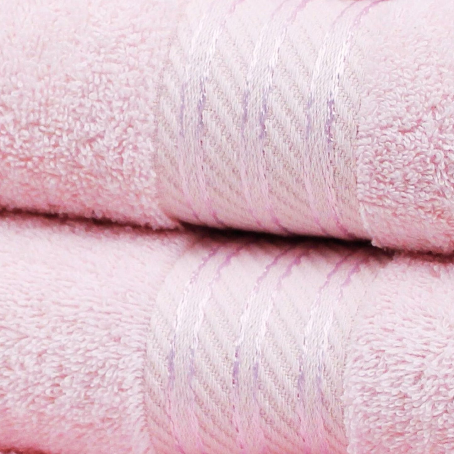 Close-up of two blush pink towels with a soft texture.