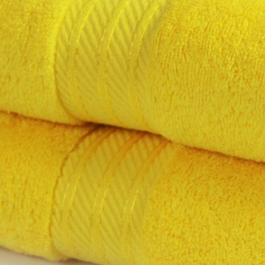 Close up of 500 GSM bath towels in yellow made from fine combed cotton